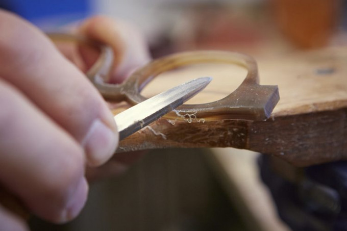 Feilen in reiner Handarbeit gehört bei der Herstellung von Büffelhornbrillen zum Entstehungsprozess dazu.