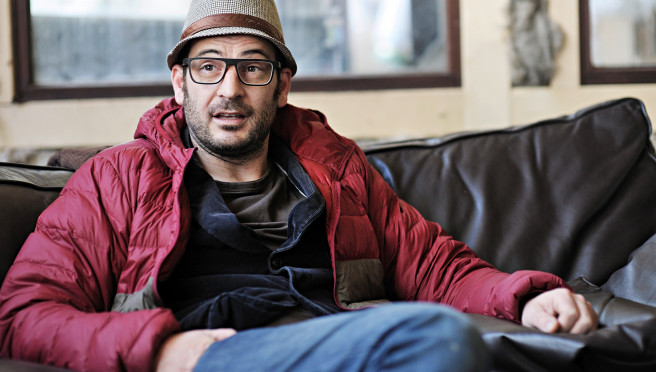 Roland Wolf, Inhaber von ROLF Spectacles entspannt auf einem Sofa in der Manufaktur in Tirol.