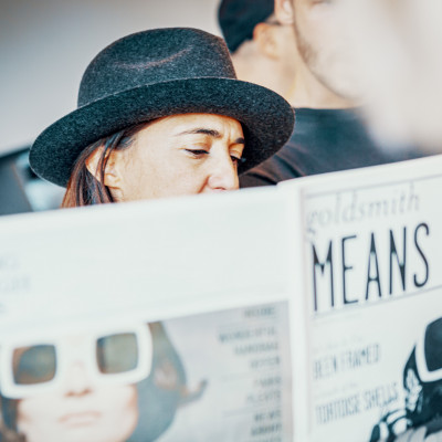 Claire Goldsmith, Inhaberin von Oliver Goldsmith Sunglasses, liest in einer Zeitung die ausschließlich über ihre Kollektion berichtet.